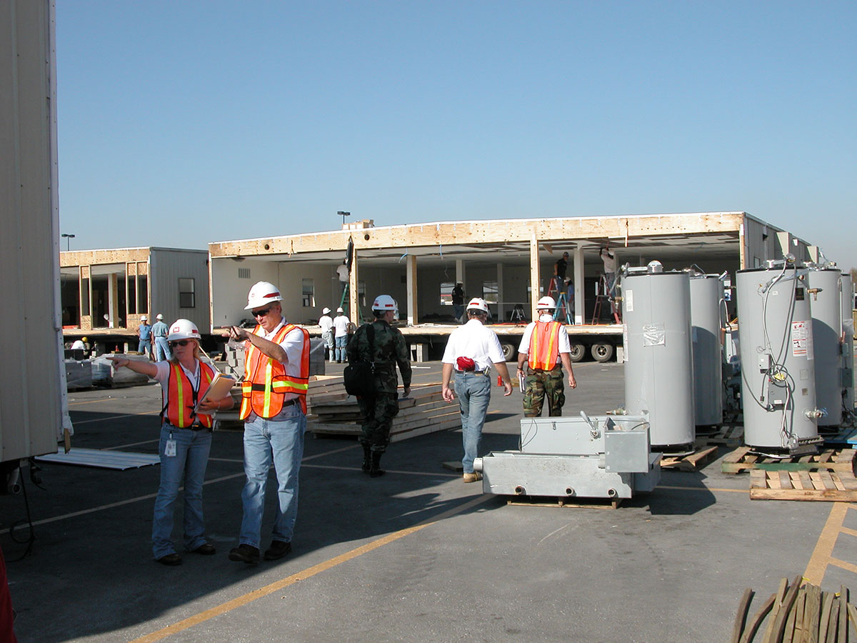 People standing outside a temporary building used as health facility